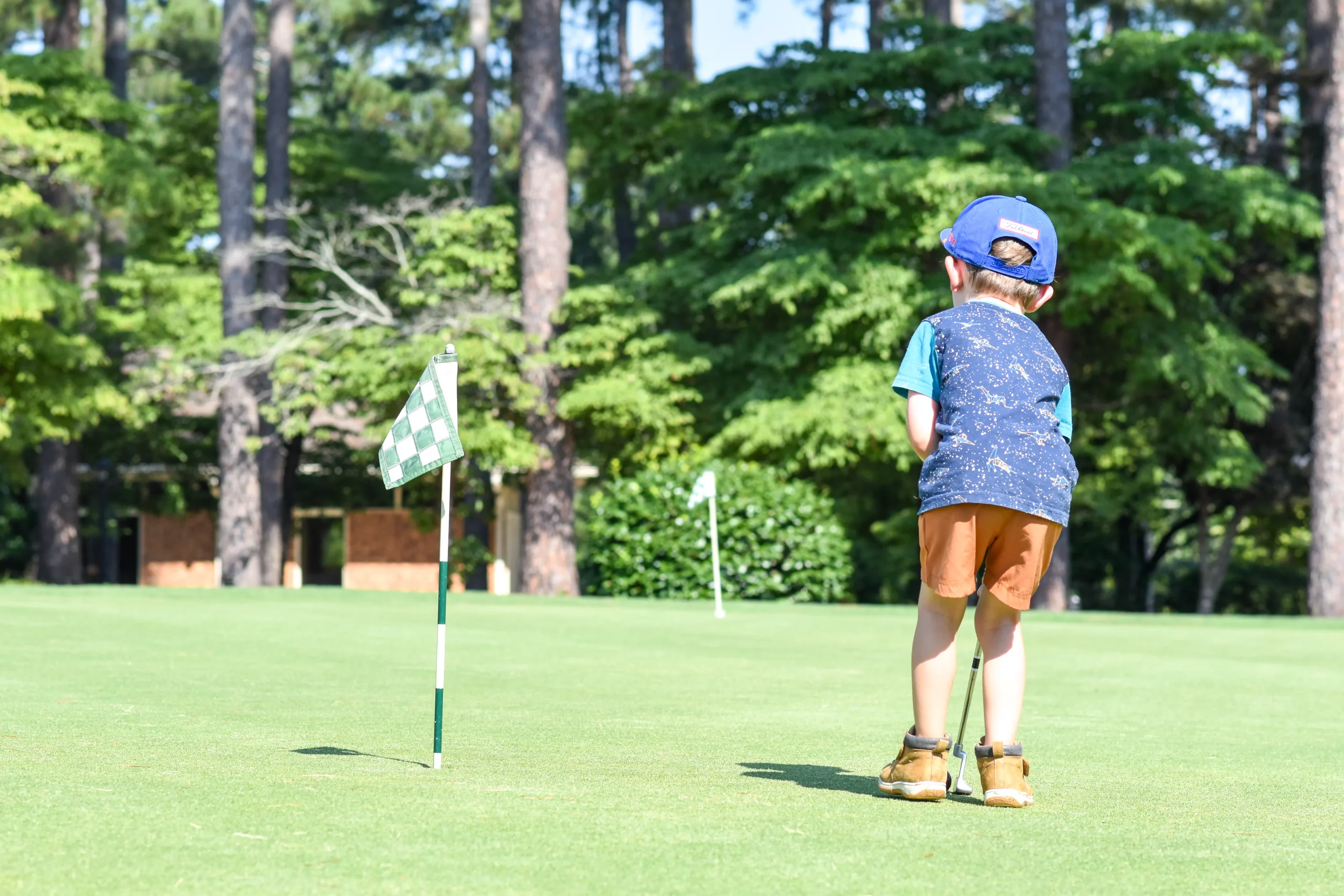 Coach Keith working with a young student at the range - The Caddie Code