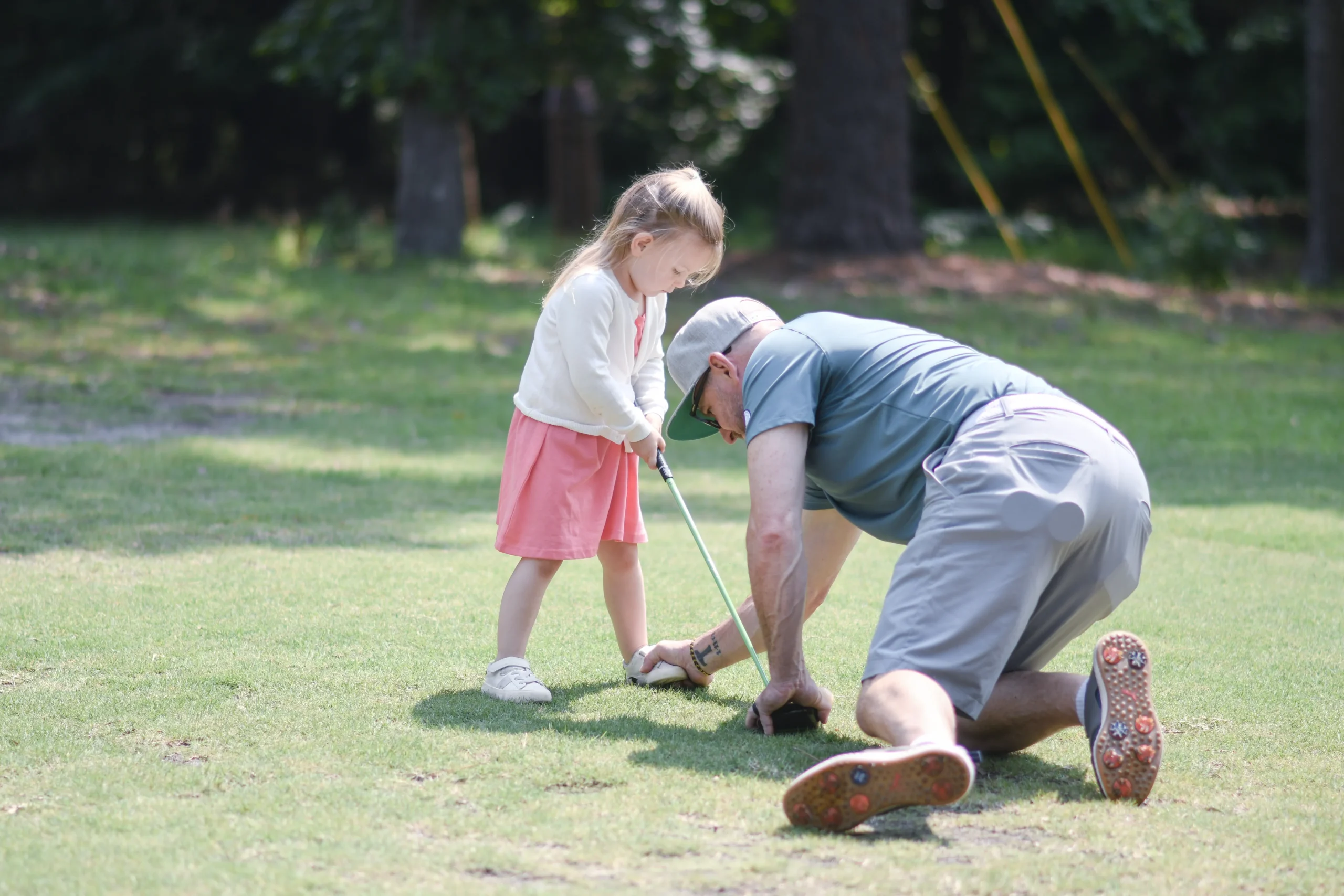 Coach and student calmly observing ball flight together - The Caddie Code tracks